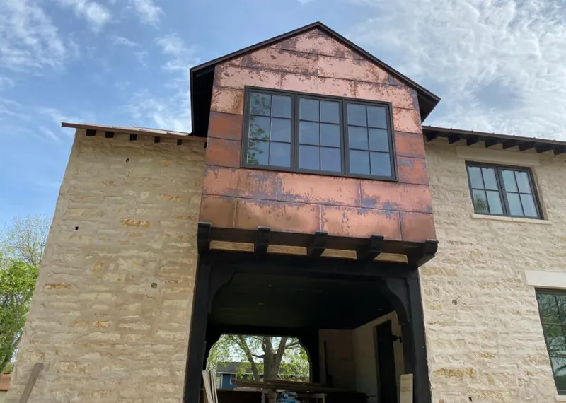 Copper metal panel facade on a stone building for Roof Repair in Nolensville